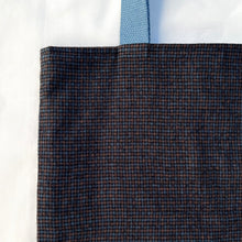 Load image into Gallery viewer, Tote bag. Luxurious fine wool fabric with small blue and brown squares and upcycled chocolate brown leather round bottom.