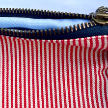 Load image into Gallery viewer, Red and white striped denim fabric and ginger brown leather Pouch with zip. Zippered purse. Zippered pouch. Cotton and leather. YKK zipper.