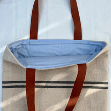 Load image into Gallery viewer, Tote bag. Heavyweight natural woven canvas with two horizontal blue grey stripes and light blue cotton denim bottom.