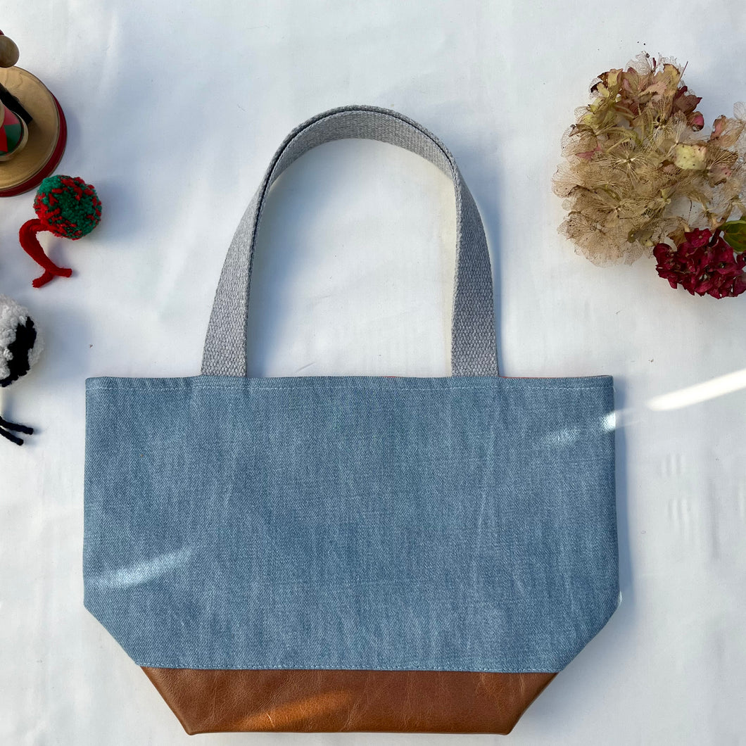 xs Handbag. Bag. Light blue cotton denim and brown leather handbag.