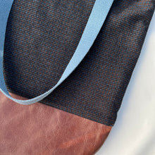 Load image into Gallery viewer, Tote bag. Luxurious fine wool fabric with small blue and brown squares and upcycled chocolate brown leather round bottom.