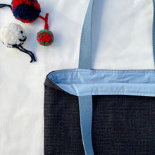 Load image into Gallery viewer, Tote bag. Luxurious fine wool fabric with small blue and brown squares and upcycled chocolate brown leather round bottom.