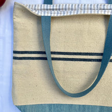 Load image into Gallery viewer, Tote bag. Heavyweight natural woven canvas with two horizontal blue stripes and light blue cotton denim bottom.