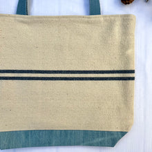 Load image into Gallery viewer, Tote bag. Heavyweight natural woven canvas with two horizontal blue stripes and light blue cotton denim bottom.