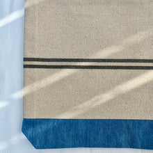 Load image into Gallery viewer, Tote bag. Heavyweight natural woven canvas with two horizontal blue grey stripes and light blue cotton denim bottom.