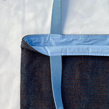 Load image into Gallery viewer, Tote bag. Luxurious fine wool fabric with small blue and brown squares and upcycled chocolate brown leather round bottom.