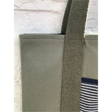 Load image into Gallery viewer, Tote bag. light khaki green canvas shopper bag with a deep front navy blue stripes denim pocket. 100% cotton.