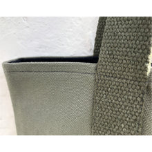 Load image into Gallery viewer, Tote bag. light khaki green canvas shopper bag with a deep front navy blue stripes denim pocket. 100% cotton.