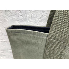 Load image into Gallery viewer, Tote bag. light khaki green canvas shopper bag with a deep front navy blue stripes denim pocket. 100% cotton.