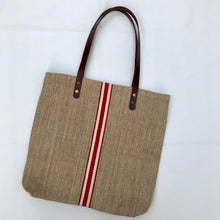 Load image into Gallery viewer, Tote bag. Vintage grain sack tote bag with brown leather straps. Handwoven. Vertical red and leather white stripes.