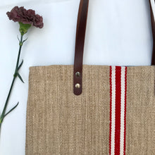 Load image into Gallery viewer, Tote bag. Vintage grain sack tote bag with brown leather straps. Handwoven. Vertical red and leather white stripes.