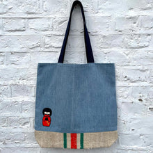 Load image into Gallery viewer, Unique tote bag. Light blue denim with embroidered patches and a vintage grain sack bottom.