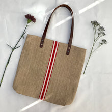 Load image into Gallery viewer, Tote bag. Vintage grain sack tote bag with brown leather straps. Handwoven. Vertical red and leather white stripes.