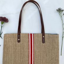 Load image into Gallery viewer, Tote bag. Vintage grain sack tote bag with brown leather straps. Handwoven. Vertical red and leather white stripes.