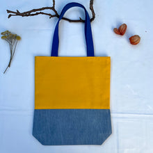 Load image into Gallery viewer, Tote bag. Canary yellow and blue denim cotton canvas tote bag. Lined with a midnight blue pattern cotton fabric.