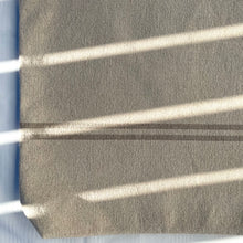 Load image into Gallery viewer, Tote bag. Heavyweight natural woven canvas with two horizontal sand-coloured stripes. Lined with a striped cotton shirting fabric.
