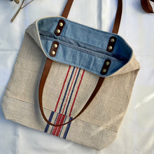 Load image into Gallery viewer, Tote bag. Vintage grain sack tote bag with leather straps. Vertical deep red stripes.