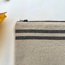 Load image into Gallery viewer, Cream woven canvas pouch with two horizontal grey stripes. YKK zip. Zippered purse. Zippered pouch. YKK zipper.