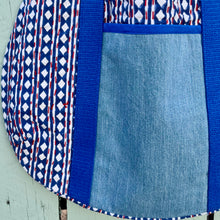 Load image into Gallery viewer, Block print bowling bag. Blue and white cotton print with red visible stitch. Red, navy blue and white knit cuff.
