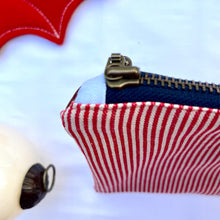 Load image into Gallery viewer, Red and white striped denim fabric and ginger brown leather Pouch with zip. Zippered purse. Zippered pouch. Cotton and leather. YKK zipper.
