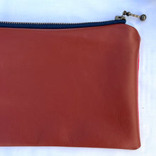 Load image into Gallery viewer, Red and white striped denim fabric and ginger brown leather Pouch with zip. Zippered purse. Zippered pouch. Cotton and leather. YKK zipper.
