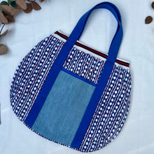 Load image into Gallery viewer, Block print bowling bag. Blue and white cotton print with red visible stitch. Red, navy blue and white knit cuff.
