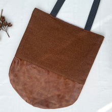 Load image into Gallery viewer, Tote bag. Luxurious brown wool fabric and distressed brown leather round bottom.

