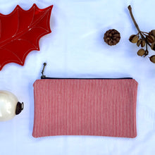 Load image into Gallery viewer, Red and white striped denim fabric and ginger brown leather Pouch with zip. Zippered purse. Zippered pouch. Cotton and leather. YKK zipper.
