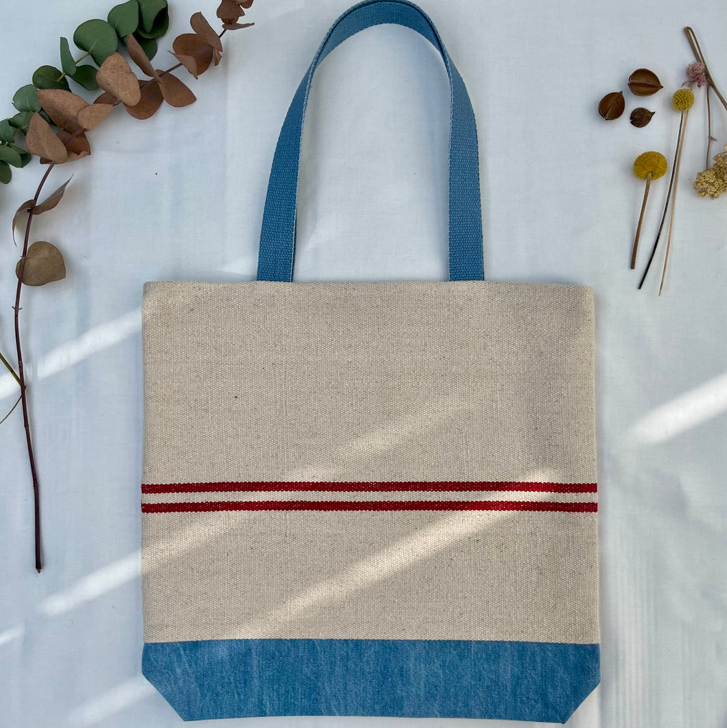 Tote bag. Heavyweight natural woven canvas with two horizontal red stripes and light blue cotton denim bottom.