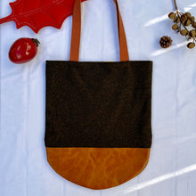 Load image into Gallery viewer, Tote bag. Luxurious dark olive green tweed wool fabric and saddle brown leather round bottom.
