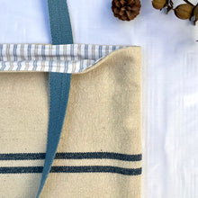 Load image into Gallery viewer, Tote bag. Heavyweight natural woven canvas with two horizontal blue stripes and light blue cotton denim bottom.
