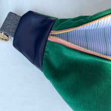 Load image into Gallery viewer, One-of-a-kind tote sling bag. Luxurious green cotton needlecord. With navy blue leather sides. Lined with a gorgeous blue and green striped cotton poplin fabric.
