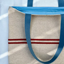 Load image into Gallery viewer, Tote bag. Heavyweight natural woven canvas with two horizontal red stripes and light blue cotton denim bottom.

