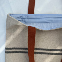 Load image into Gallery viewer, Tote bag. Heavyweight natural woven canvas with two horizontal blue grey stripes and light blue cotton denim bottom.

