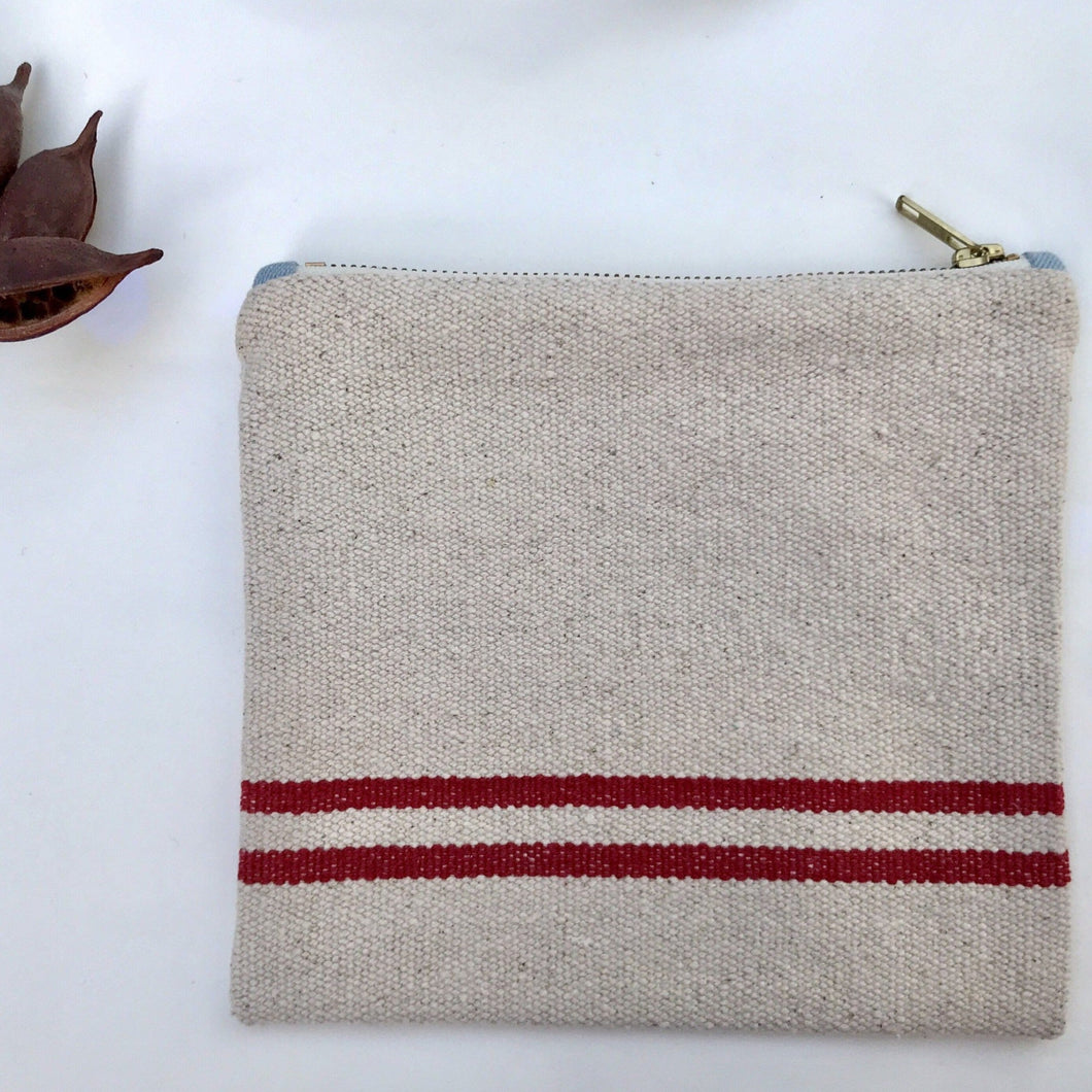Natural woven canvas pouch with red horizontal stripes. Zippered purse. Zippered pouch. YKK metal zipper.