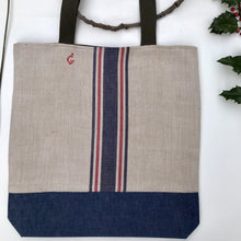 Load image into Gallery viewer, Tote bag. Vintage cotton and hemp grain sack. Blue and red stripes. Blue denim bottom.
