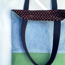 Load image into Gallery viewer, Tote bag. Light blue denim and green cotton canvas tote bag. Lined with a cherries pattern cotton fabric.

