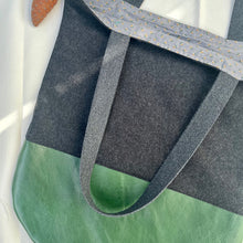 Load image into Gallery viewer, Tote bag. Dark grey wool tote with a green leather round bottom.
