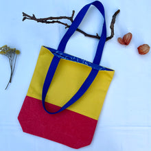 Load image into Gallery viewer, Tote bag. Vibrant yellow and red cotton canvas tote bag. Lined with a royal blue pattern cotton fabric.
