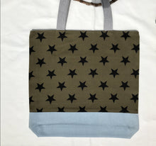 Load image into Gallery viewer, Tote bag. Khaki green twill cotton canvas with big black stars, fabric by a famous Italian designer house. Light blue cotton denim bottom.
