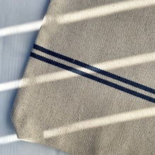 Load image into Gallery viewer, Tote bag. Heavyweight natural woven canvas with two horizontal blue stripes. Lined with a striped cotton shirting fabric.
