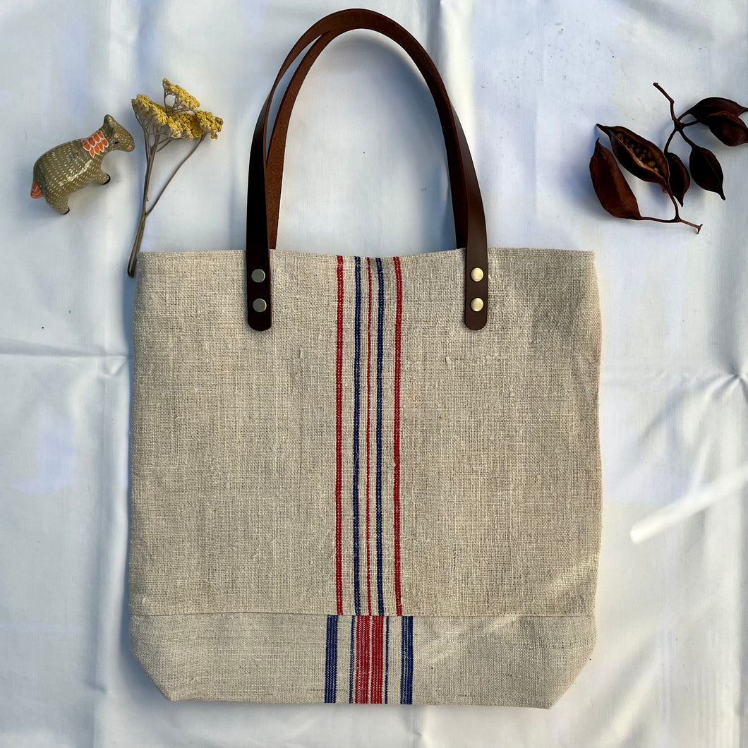 Tote bag. Vintage grain sack tote bag with leather straps. Vertical deep red stripes.