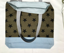 Load image into Gallery viewer, Tote bag. Khaki green twill cotton canvas with big black stars, fabric by a famous Italian designer house. Light blue cotton denim bottom.
