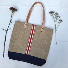 Load image into Gallery viewer, Tote bag. Vintage grain sack tote bag with brown leather straps. Handwoven. Vertical red and leather white stripes.

