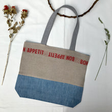 Load image into Gallery viewer, Tote Bag. 100% French linen fabric « Bon appétit » with a light blue denim bottom.

