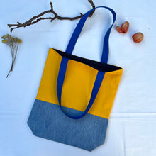 Load image into Gallery viewer, Tote bag. Canary yellow and blue denim cotton canvas tote bag. Lined with a midnight blue pattern cotton fabric.
