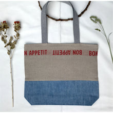 Load image into Gallery viewer, Tote Bag. 100% French linen fabric « Bon appétit » with a light blue denim bottom.
