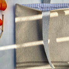 Load image into Gallery viewer, Tote bag. Heavyweight natural woven canvas with two horizontal sand-coloured stripes. Lined with a striped cotton shirting fabric.

