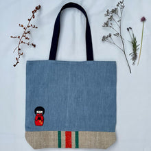 Load image into Gallery viewer, Unique tote bag. Light blue denim with embroidered patches and a vintage grain sack bottom.
