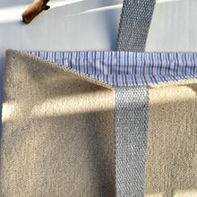 Load image into Gallery viewer, Tote bag. Heavyweight natural woven canvas with two horizontal sand-coloured stripes. Lined with a striped cotton shirting fabric.
